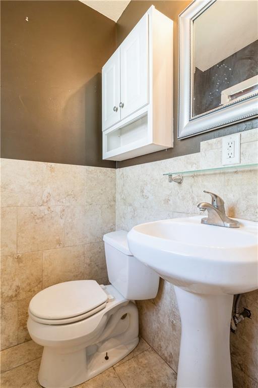 5431 Switzer Rd, Merriam, KS 66203 - half bath with tile walls and tile patterned floors