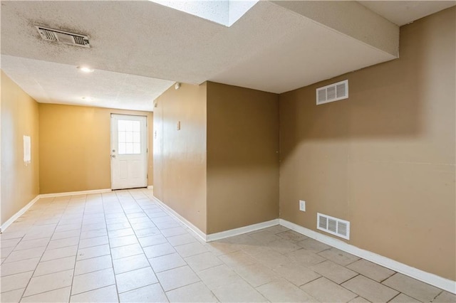 5431 Switzer Rd, Merriam, KS 66203 - spare room with a textured ceiling and light tile patterned floors
