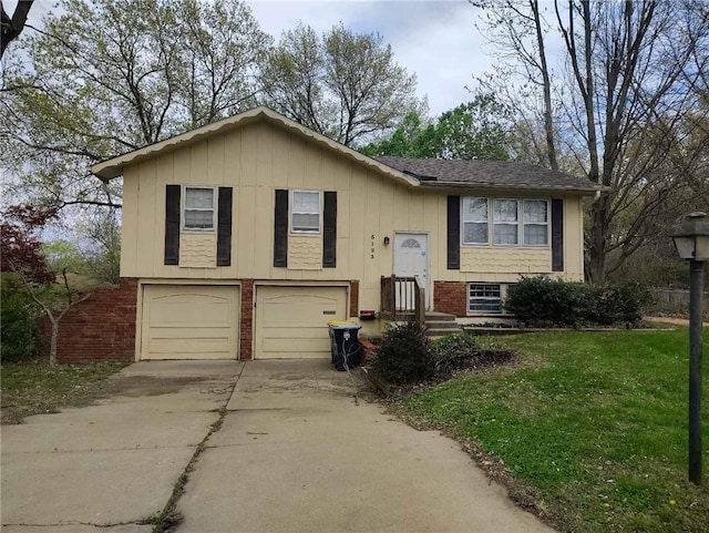 raised ranch featuring an attached garage, a front lawn, brick siding, and concrete driveway