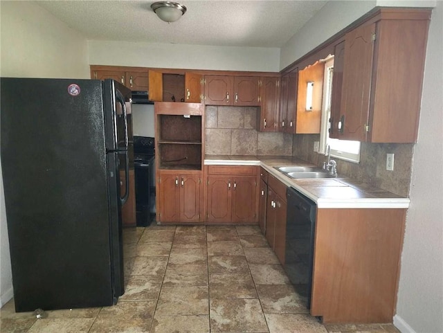 kitchen featuring open shelves, a sink, black appliances, light countertops, and backsplash