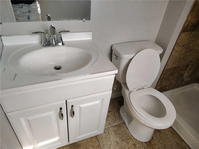 bathroom featuring tile patterned flooring, toilet, walk in shower, and vanity