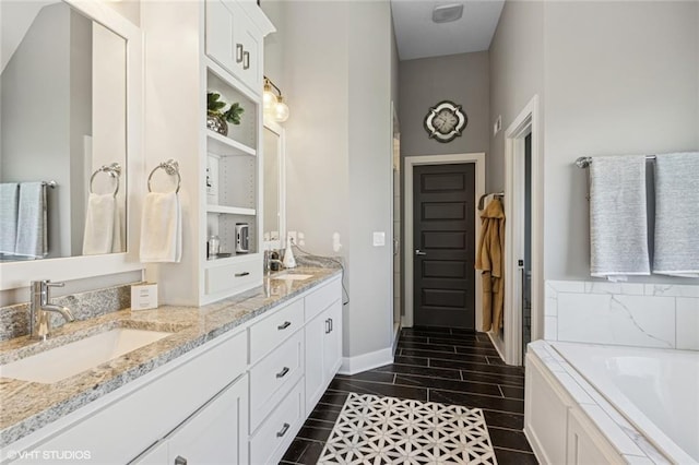 bathroom with a sink, a bath, baseboards, and double vanity