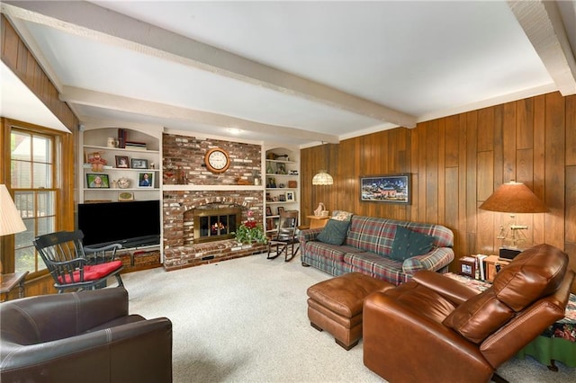 carpeted living area with beam ceiling, wooden walls, a fireplace, and built in features