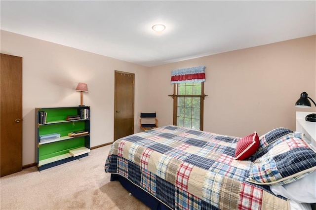 carpeted bedroom featuring baseboards
