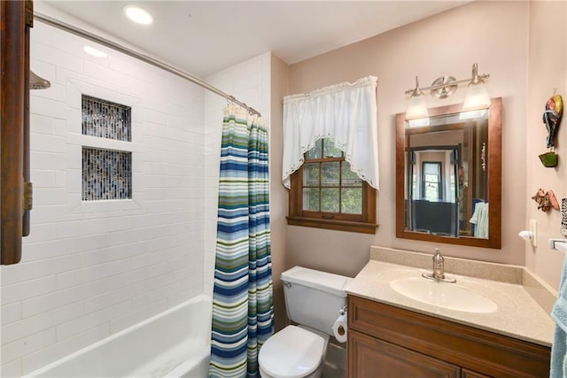 bathroom featuring vanity, shower / bathtub combination with curtain, and toilet
