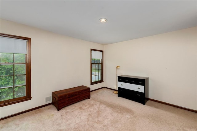 unfurnished bedroom with light colored carpet, baseboards, and recessed lighting