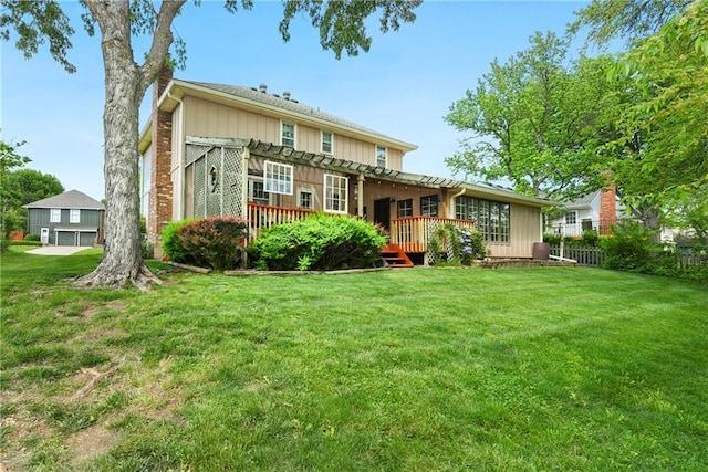 rear view of property with a pergola, a deck, and board and batten siding