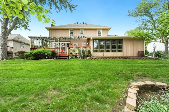 rear view of property with a wooden deck, a yard, and a pergola
