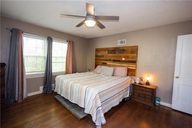 bedroom featuring wood finished floors, visible vents, baseboards, and ceiling fan