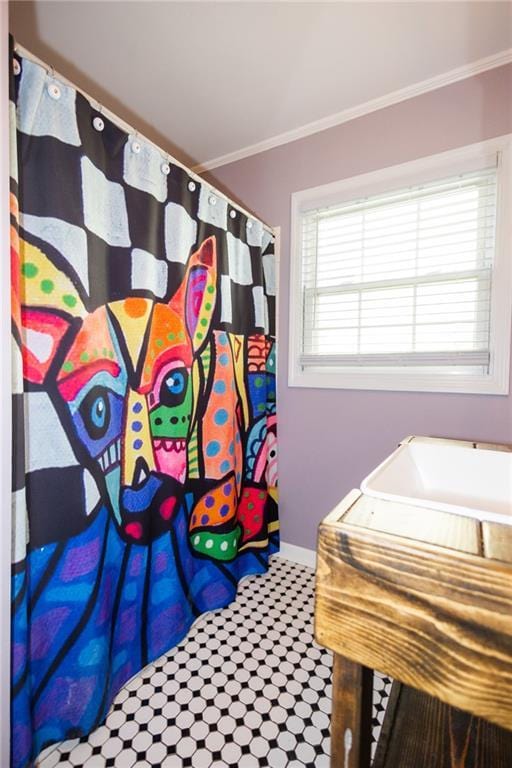 full bathroom featuring baseboards, curtained shower, and ornamental molding