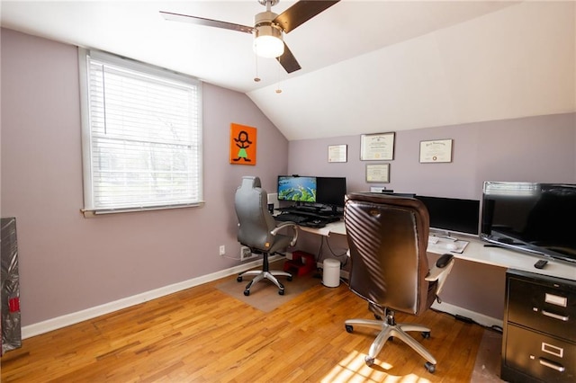 office space with vaulted ceiling, a ceiling fan, wood finished floors, and baseboards