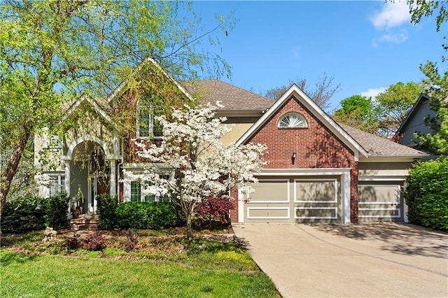 traditional-style house featuring brick siding, a garage, and concrete driveway