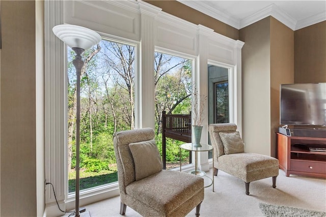 sitting room featuring crown molding and carpet