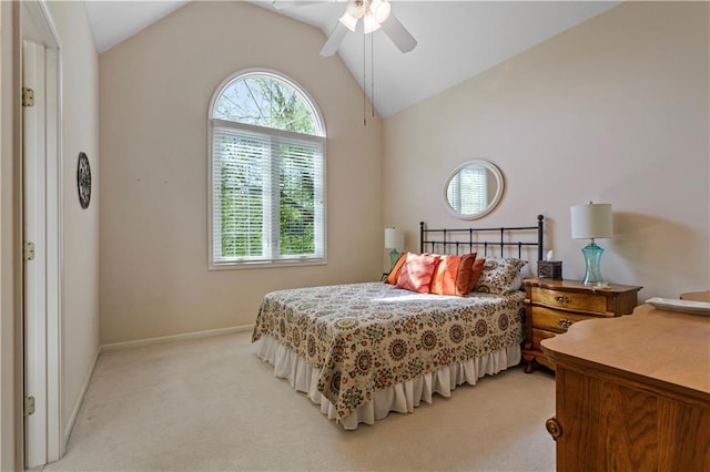 bedroom with baseboards, a ceiling fan, vaulted ceiling, and light colored carpet