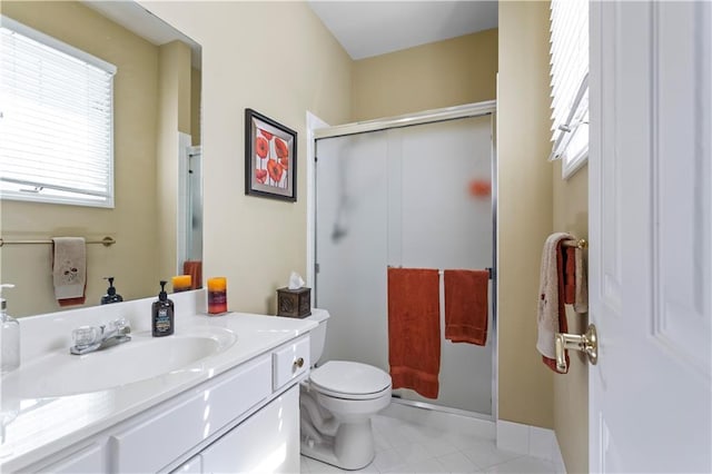 full bathroom with vanity, tile patterned flooring, a stall shower, and toilet