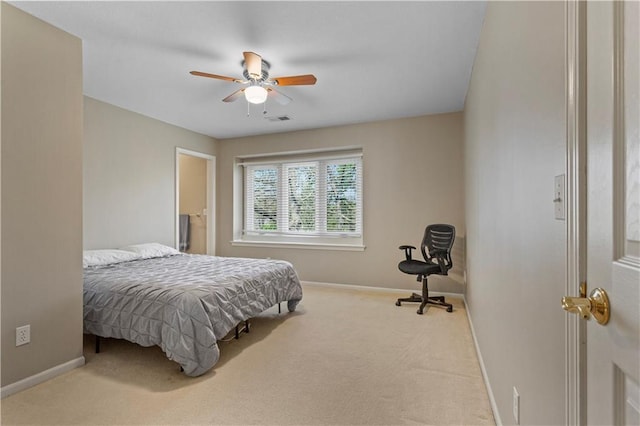 carpeted bedroom with a ceiling fan, baseboards, and visible vents
