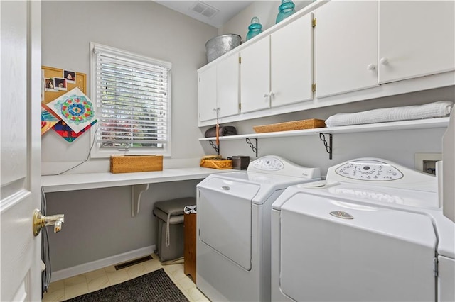 laundry area featuring visible vents, washer and clothes dryer, cabinet space, and light tile patterned flooring