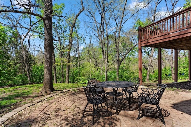 view of patio featuring a wooden deck and outdoor dining space
