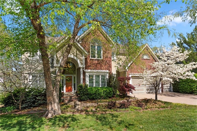 traditional-style home with brick siding, a garage, and driveway