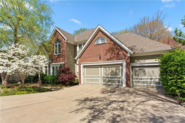 view of front of home with an attached garage, concrete driveway, and brick siding
