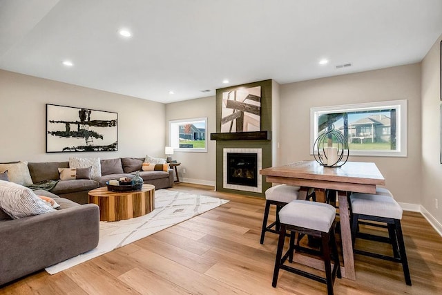 16159 S Kaw St, Olathe, KS 66062 - living area with light wood-style flooring, baseboards, a fireplace, and recessed lighting