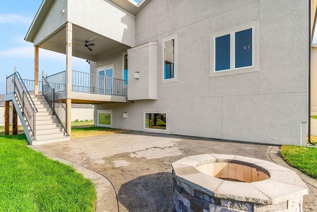 16159 S Kaw St, Olathe, KS 66062 - view of patio / terrace featuring stairway, a ceiling fan, and a fire pit