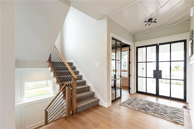 15436 W 161st Ter, Olathe, KS 66062 - doorway to outside featuring french doors, wood finished floors, stairway, lofted ceiling, and baseboards