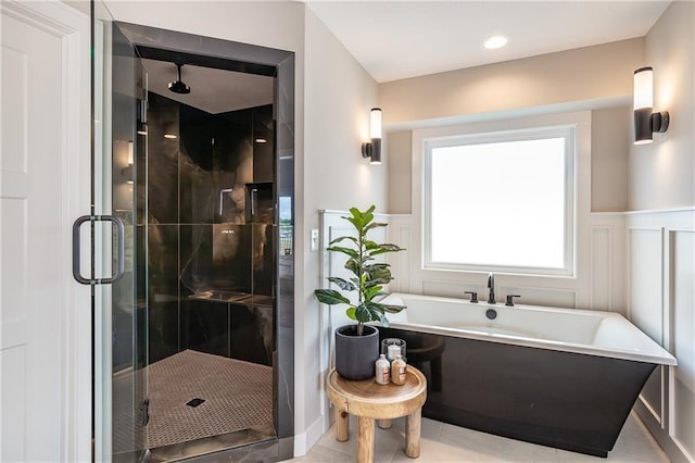 15436 W 161st Ter, Olathe, KS 66062 - full bath with a shower stall, a freestanding tub, a decorative wall, wainscoting, and tile patterned floors