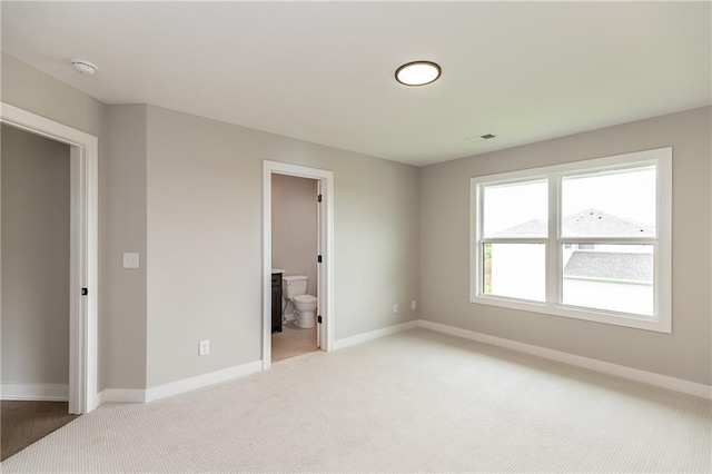 15436 W 161st Ter, Olathe, KS 66062 - unfurnished bedroom featuring light carpet, baseboards, and connected bathroom