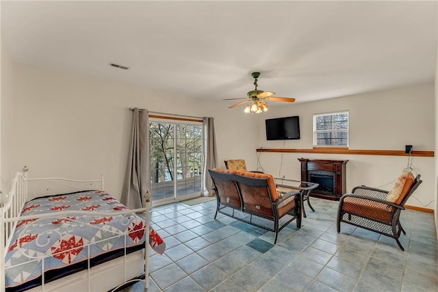 4955 Saratoga Dr, Mclouth, KS 66054 - bedroom featuring visible vents, ceiling fan, a fireplace, tile patterned floors, and access to outside