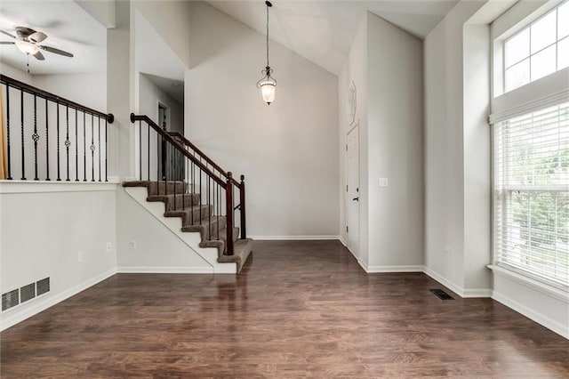 foyer with visible vents, a ceiling fan, stairs, and wood finished floors