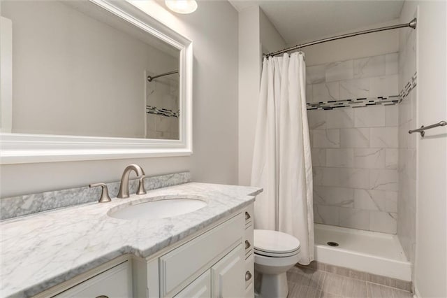 full bathroom featuring vanity, tile patterned flooring, toilet, and a shower stall
