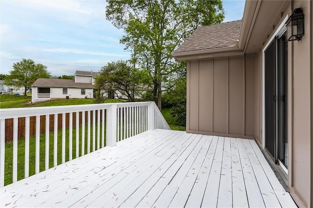 wooden terrace with a lawn