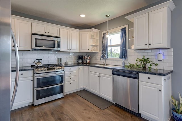 50 N 80th Pl, Kansas City, KS 66111 - kitchen with appliances with stainless steel finishes, open shelves, a sink, white cabinetry, and dark wood finished floors