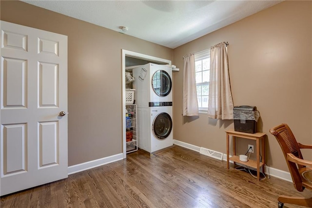 50 N 80th Pl, Kansas City, KS 66111 - laundry area featuring stacked washing machine and dryer, baseboards, and wood finished floors