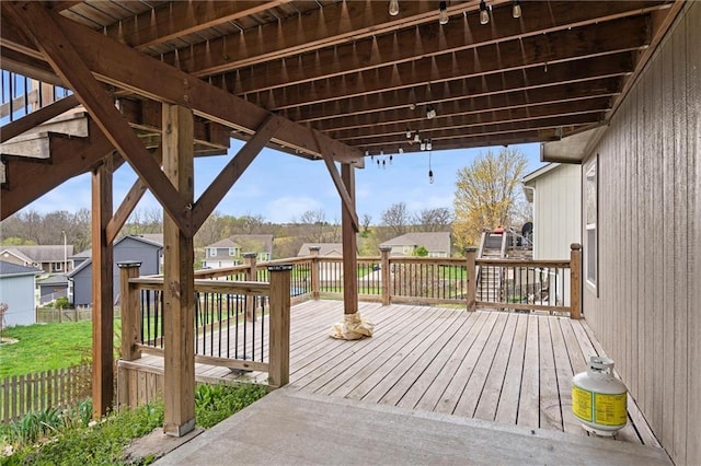 wooden terrace with a residential view and fence