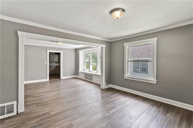 809 S Crysler Ave, Independence, MO 64052 - spare room featuring ornamental molding, wood finished floors, and baseboards