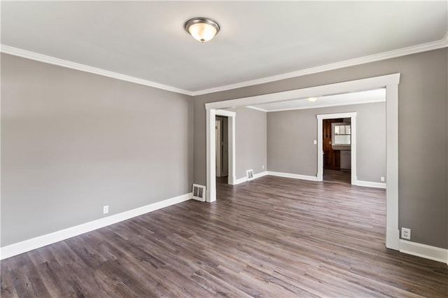 809 S Crysler Ave, Independence, MO 64052 - unfurnished room featuring crown molding, baseboards, and dark wood-type flooring