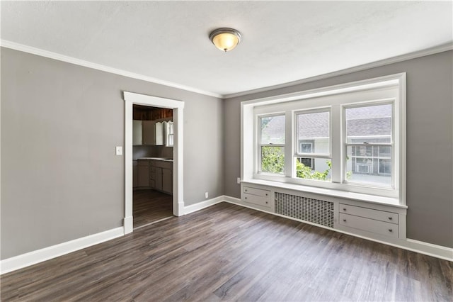 809 S Crysler Ave, Independence, MO 64052 - empty room with ornamental molding, dark wood finished floors, baseboards, and radiator