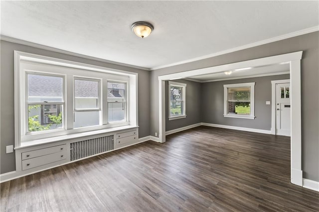 809 S Crysler Ave, Independence, MO 64052 - empty room with ornamental molding, baseboards, dark wood finished floors, and radiator