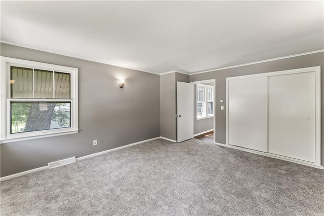 809 S Crysler Ave, Independence, MO 64052 - unfurnished bedroom featuring carpet floors, baseboards, a closet, and ornamental molding