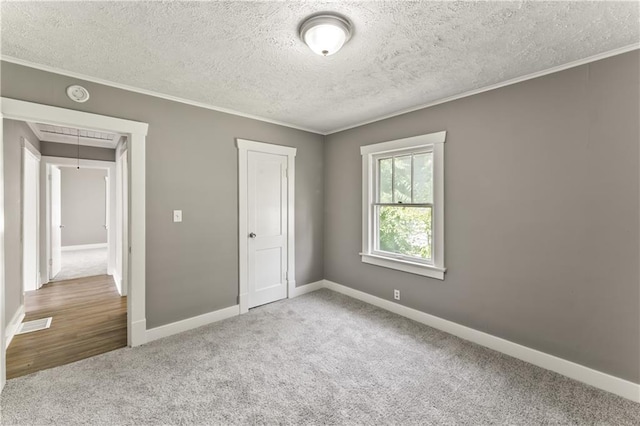 809 S Crysler Ave, Independence, MO 64052 - unfurnished bedroom with carpet flooring, attic access, ornamental molding, a textured ceiling, and baseboards