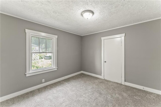 809 S Crysler Ave, Independence, MO 64052 - unfurnished room with carpet flooring, ornamental molding, baseboards, and a textured ceiling