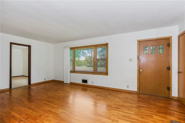 unfurnished living room featuring baseboards, light wood-style flooring, and visible vents