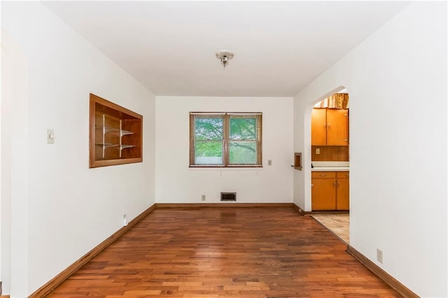 unfurnished room featuring baseboards and light wood-style flooring