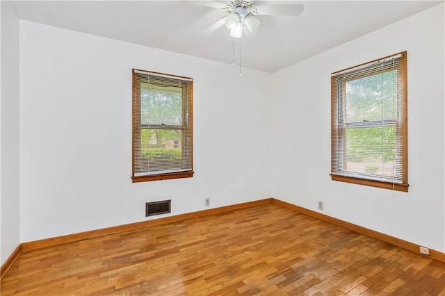 unfurnished room with visible vents, baseboards, a wealth of natural light, and light wood-type flooring