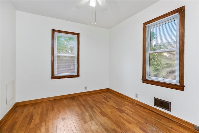 spare room with visible vents, baseboards, a healthy amount of sunlight, and light wood-type flooring