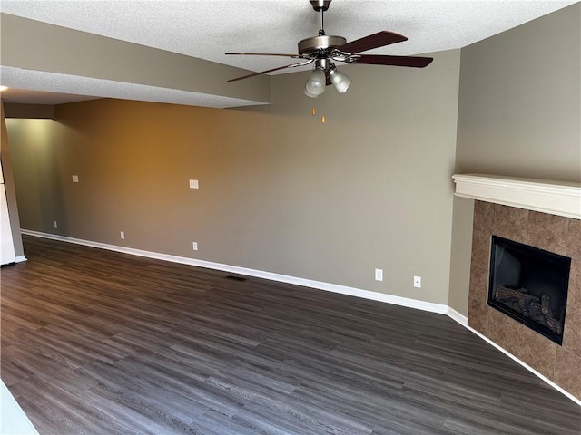 425 Hawthorne I Blvd, Warrensburg, MO 64093 - unfurnished living room featuring ceiling fan, baseboards, dark wood finished floors, and a fireplace