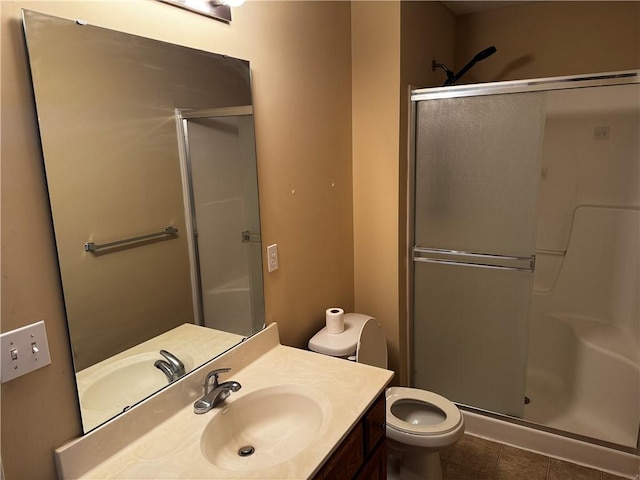 425 Hawthorne I Blvd, Warrensburg, MO 64093 - bathroom featuring toilet, a stall shower, vanity, and tile patterned floors