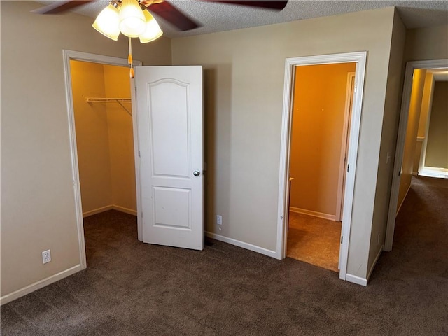 425 Hawthorne I Blvd, Warrensburg, MO 64093 - unfurnished bedroom featuring a closet, baseboards, carpet floors, a walk in closet, and ceiling fan